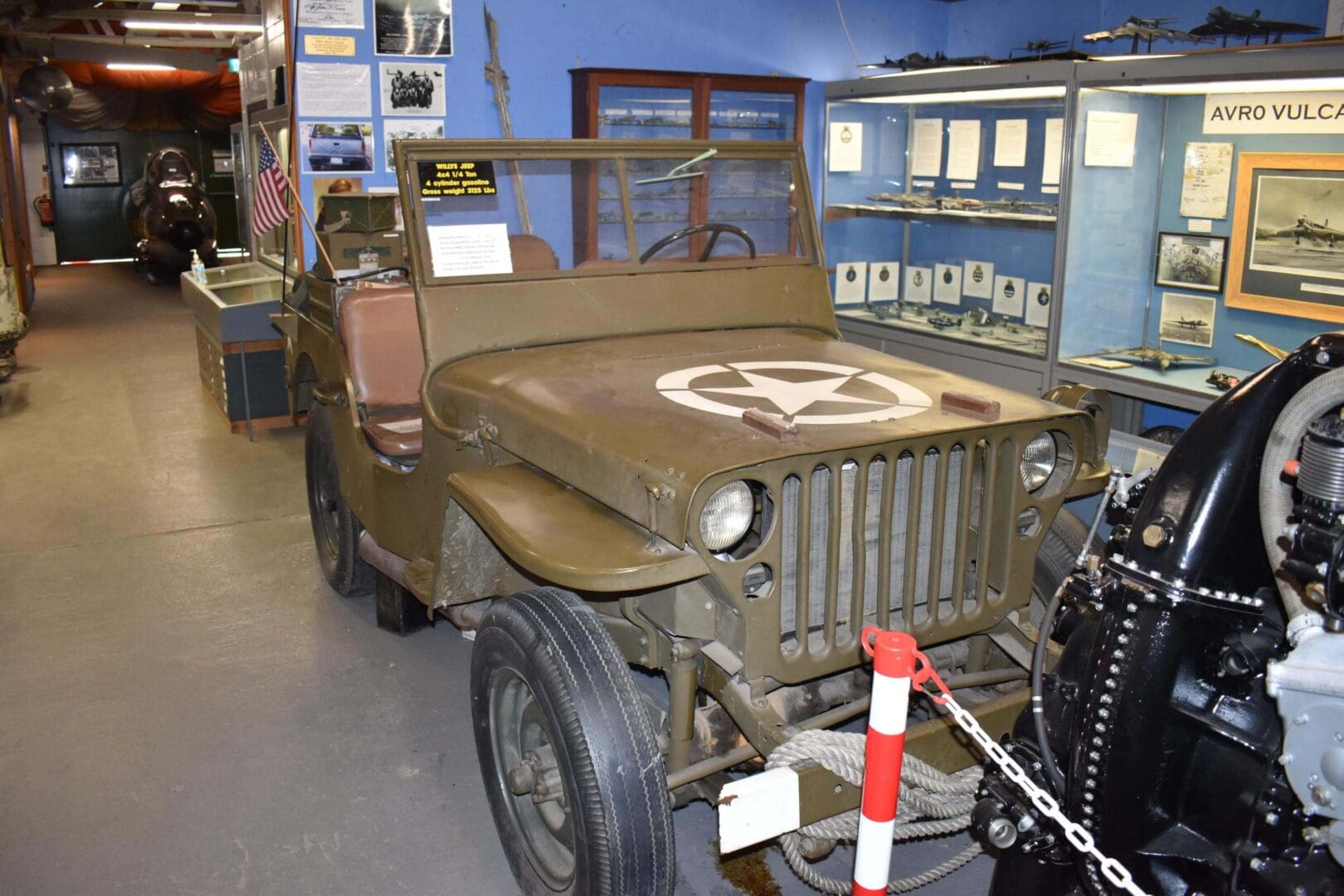 Vintage military jeep displayed in museum exhibit.