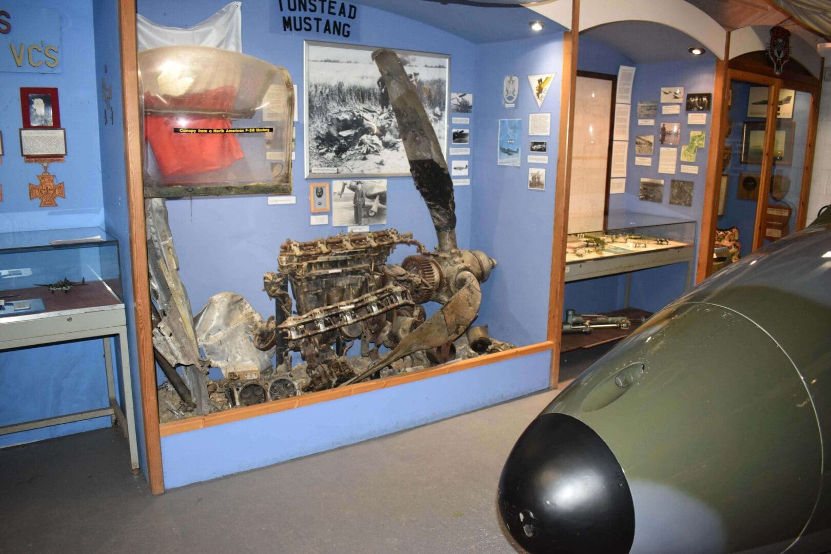 Aircraft engine and propeller display in museum.