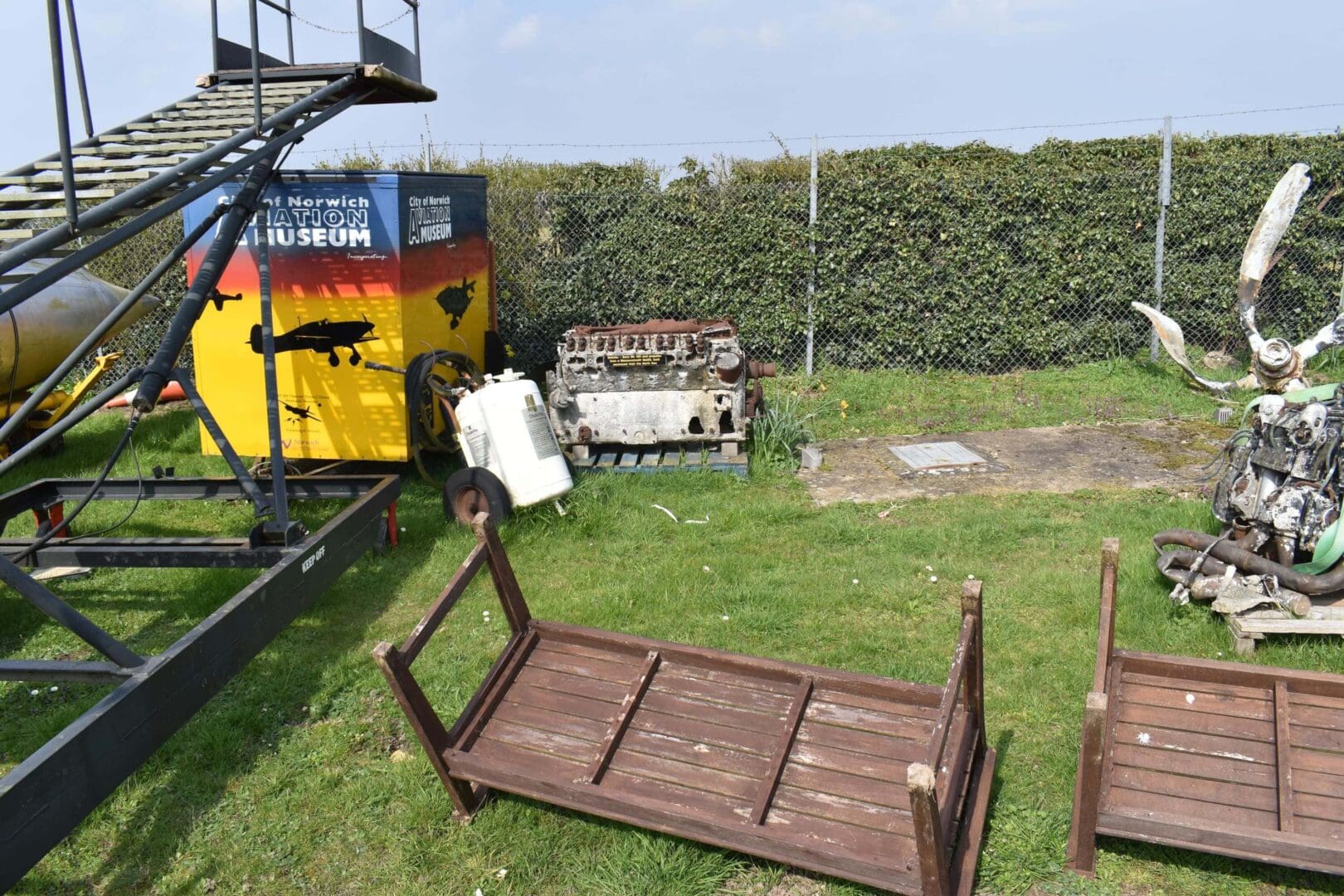 Outdoor display with machinery and overturned benches.