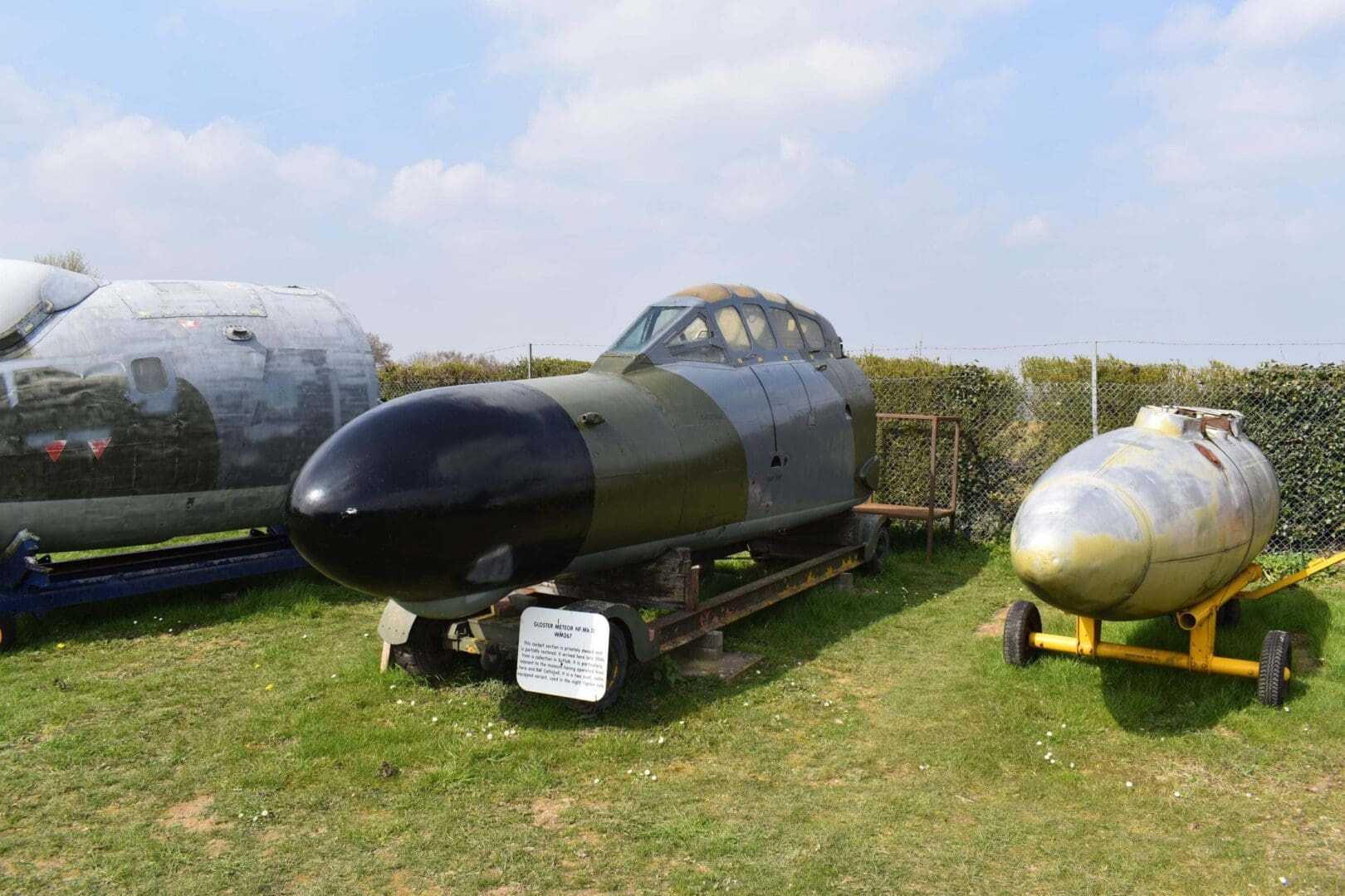 Military aircraft nose sections displayed outdoors.