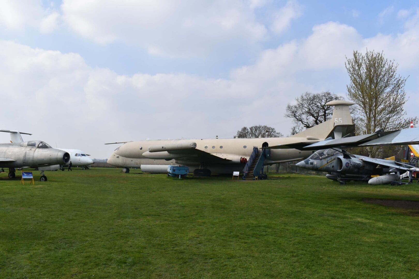Vintage military aircraft displayed on grassy field.