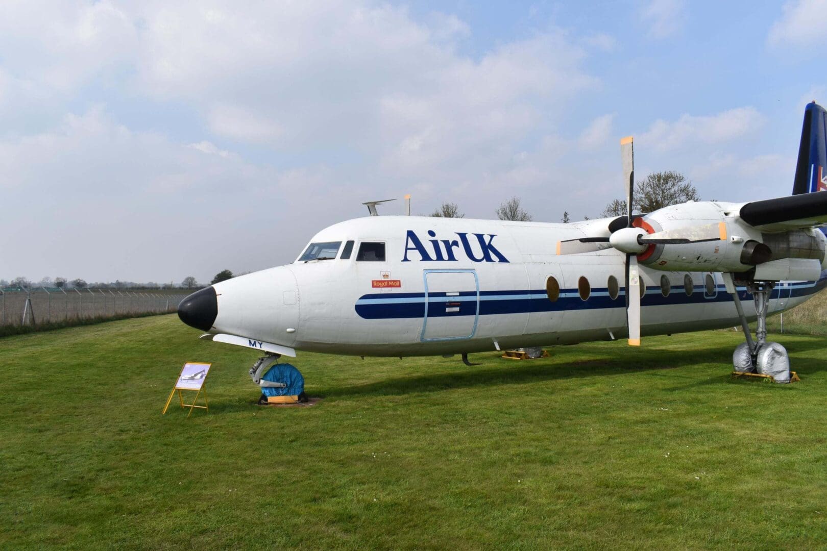 Airplane on grass with Air UK livery.