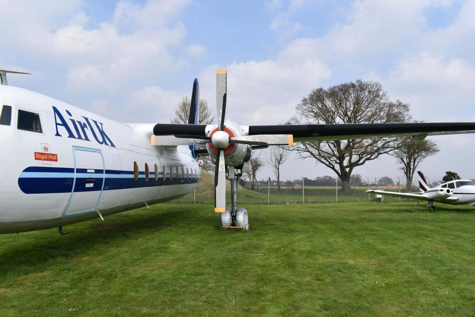 Front view of parked propeller airplane.