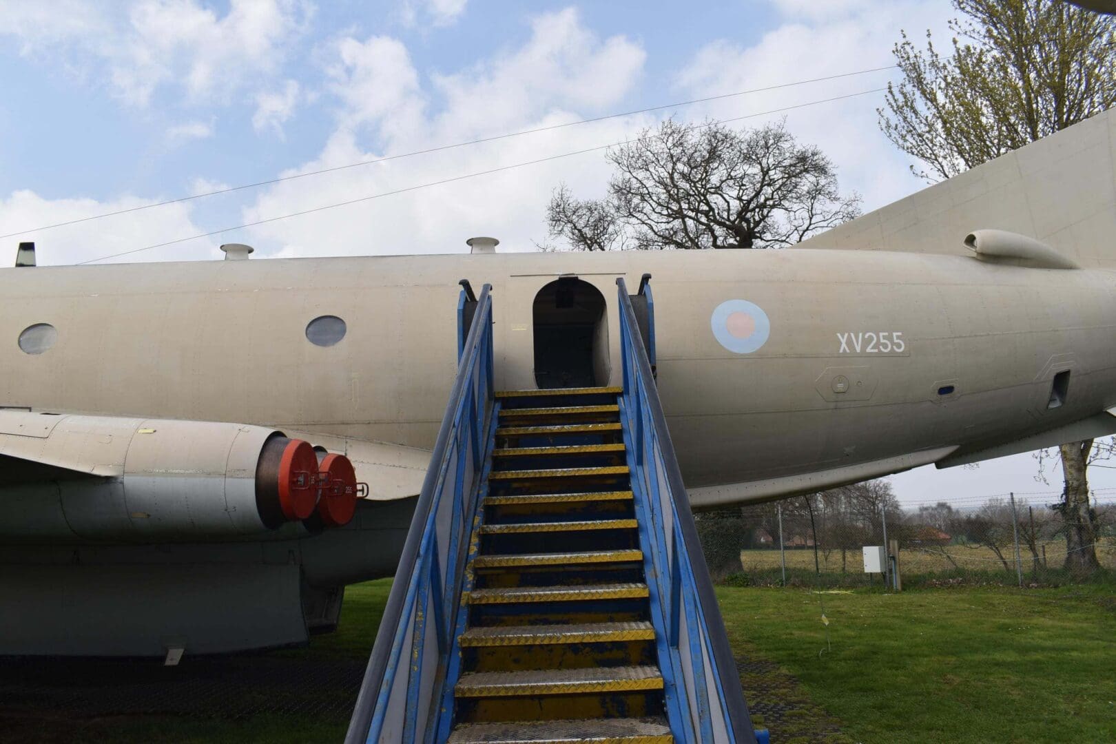 Aircraft with stairs leading to entrance.