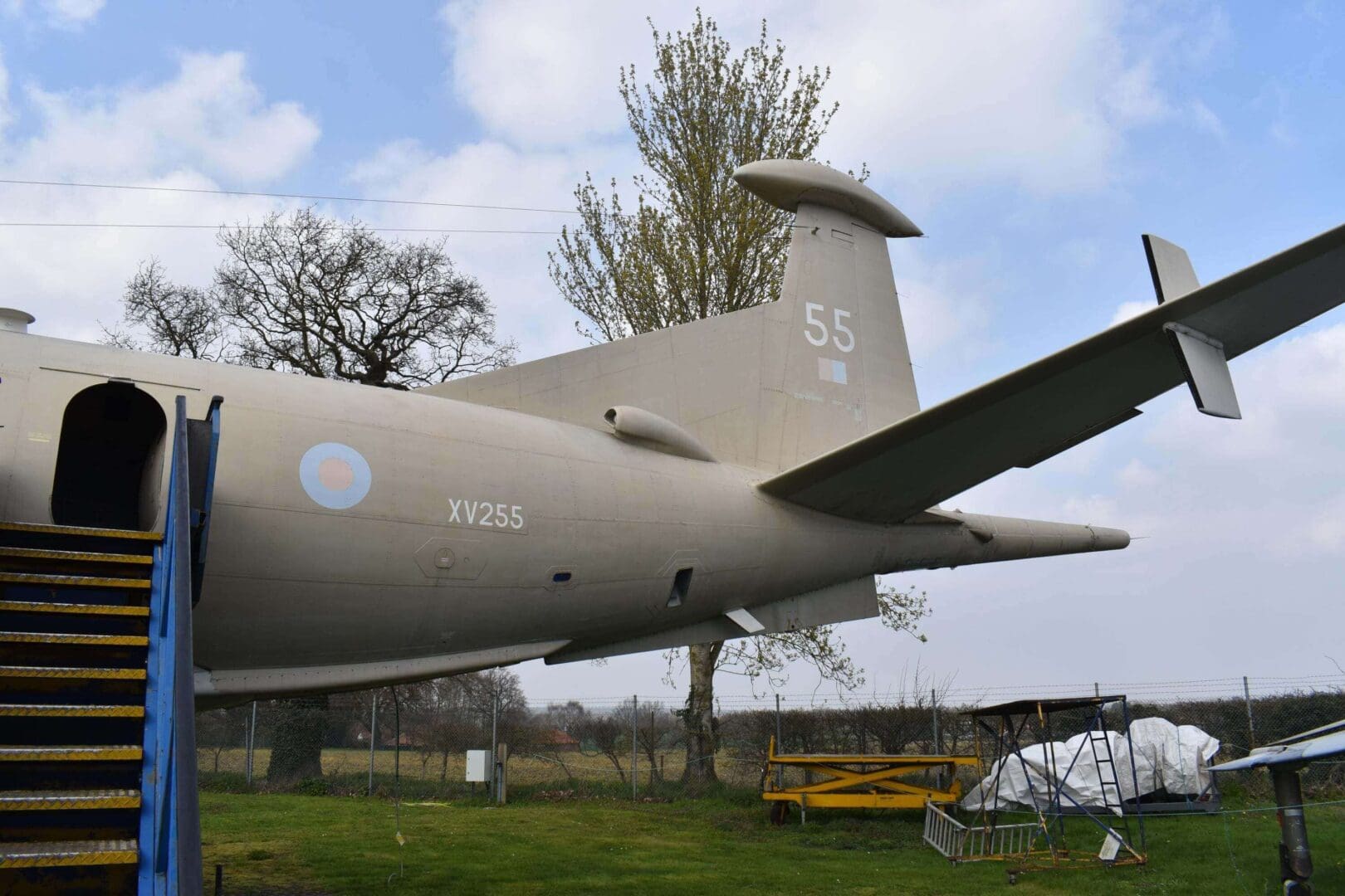 Aircraft tail section with number 55 displayed.