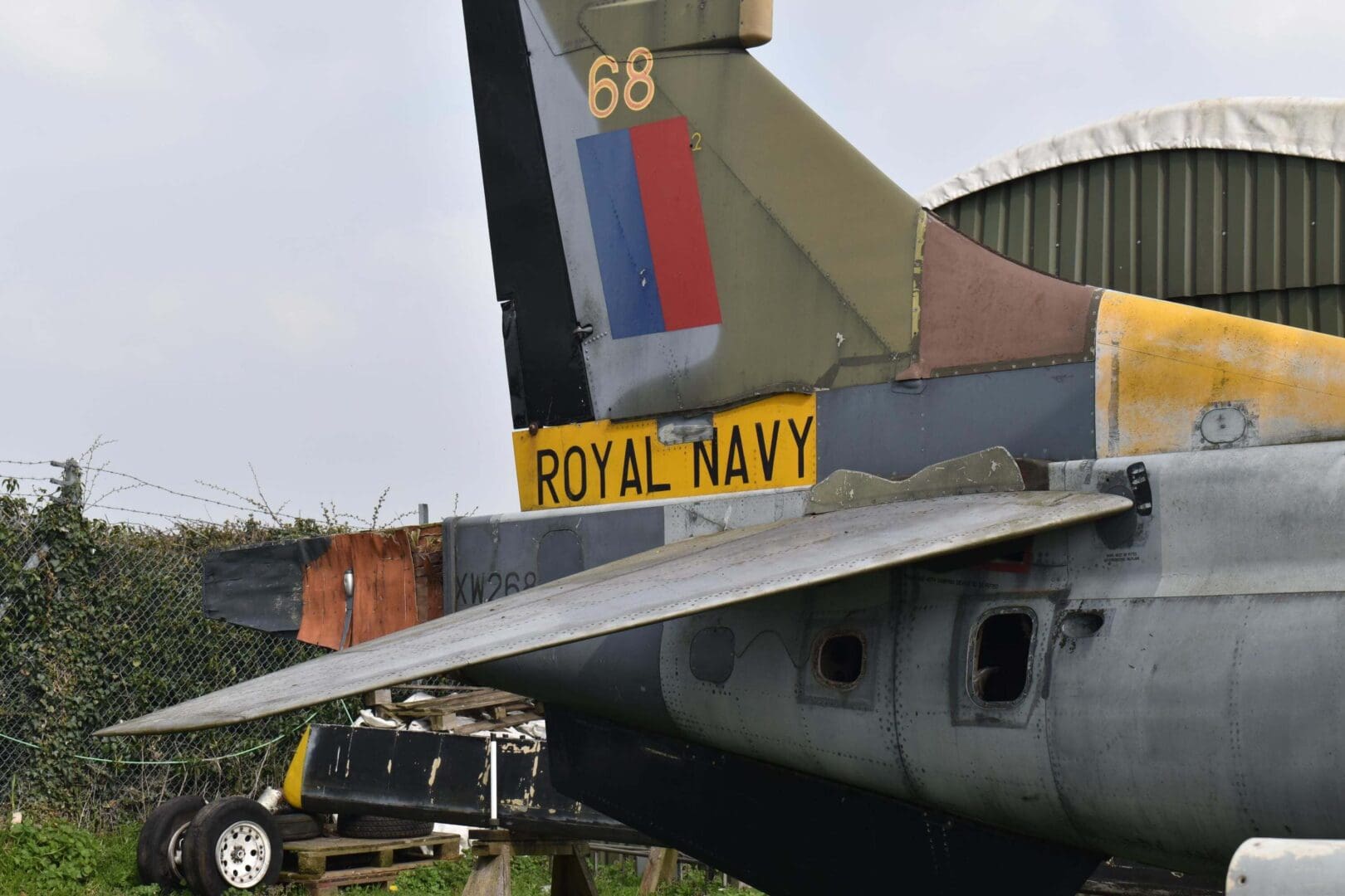 Royal Navy aircraft tail with insignia.