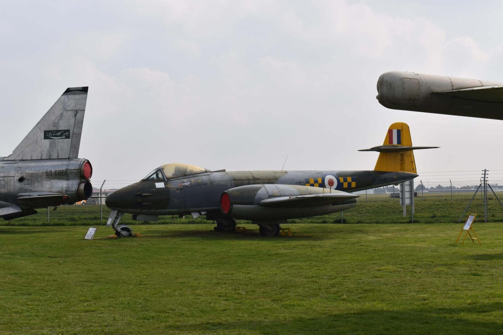 Vintage aircraft displayed on grassy field.