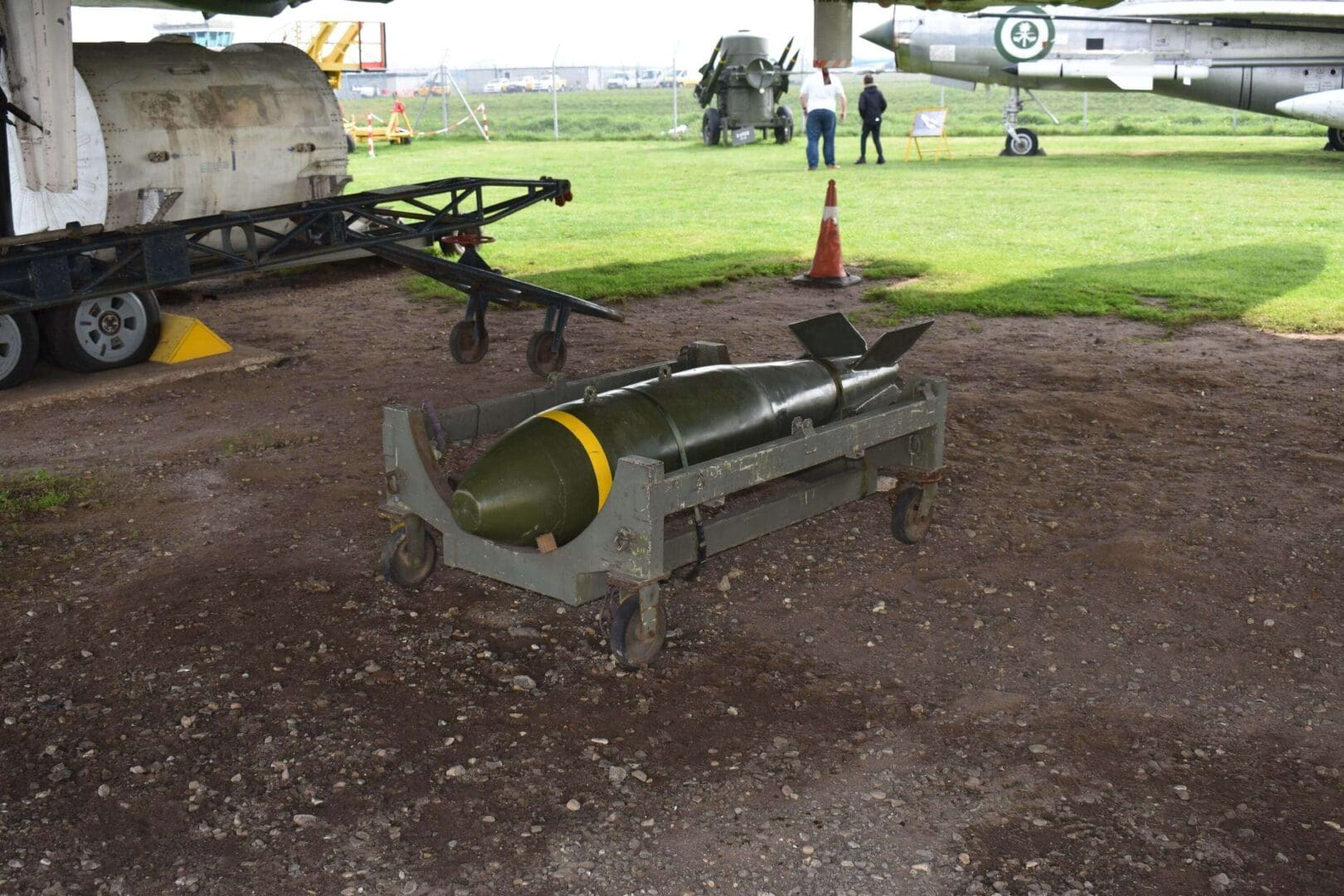 Bomb on a wheeled cart outdoors.