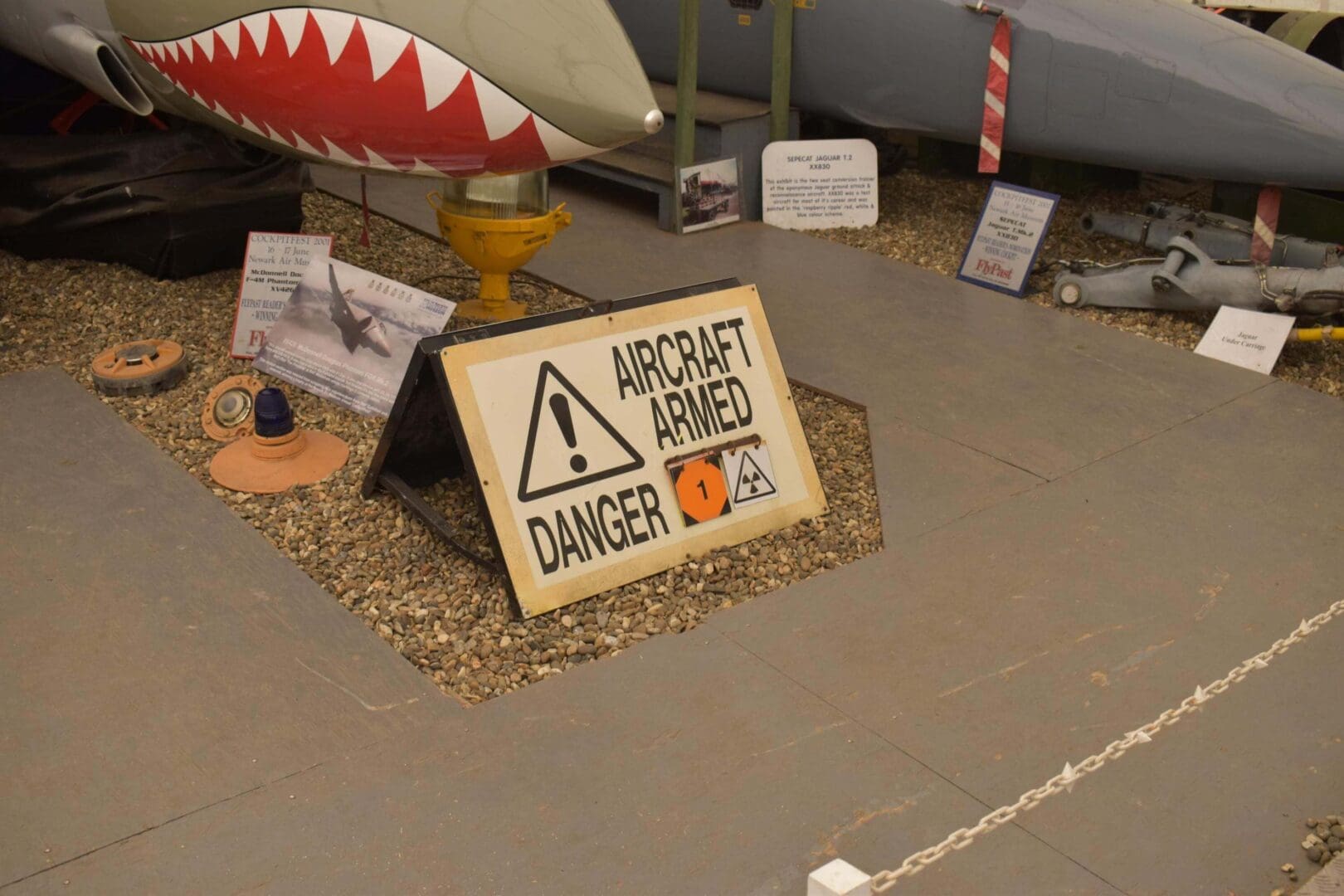 Aircraft armed danger sign near aircraft display.