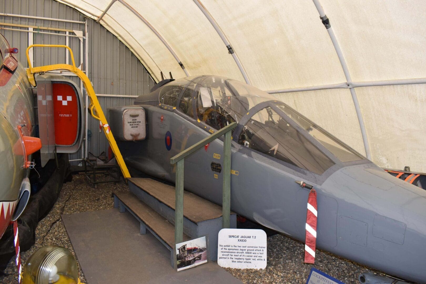 Military aircraft cockpit in museum display.
