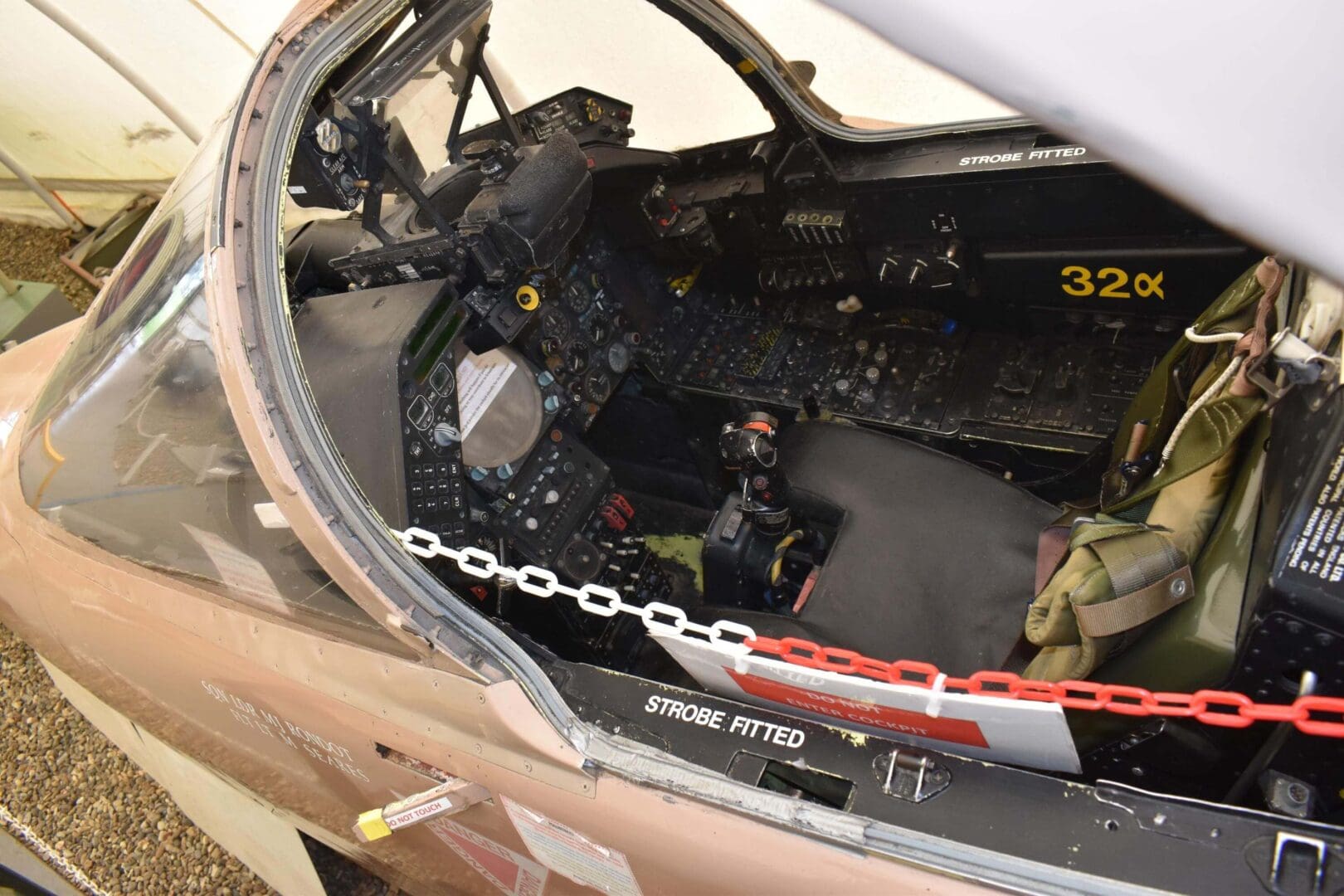 Aircraft cockpit with control panels and seat.