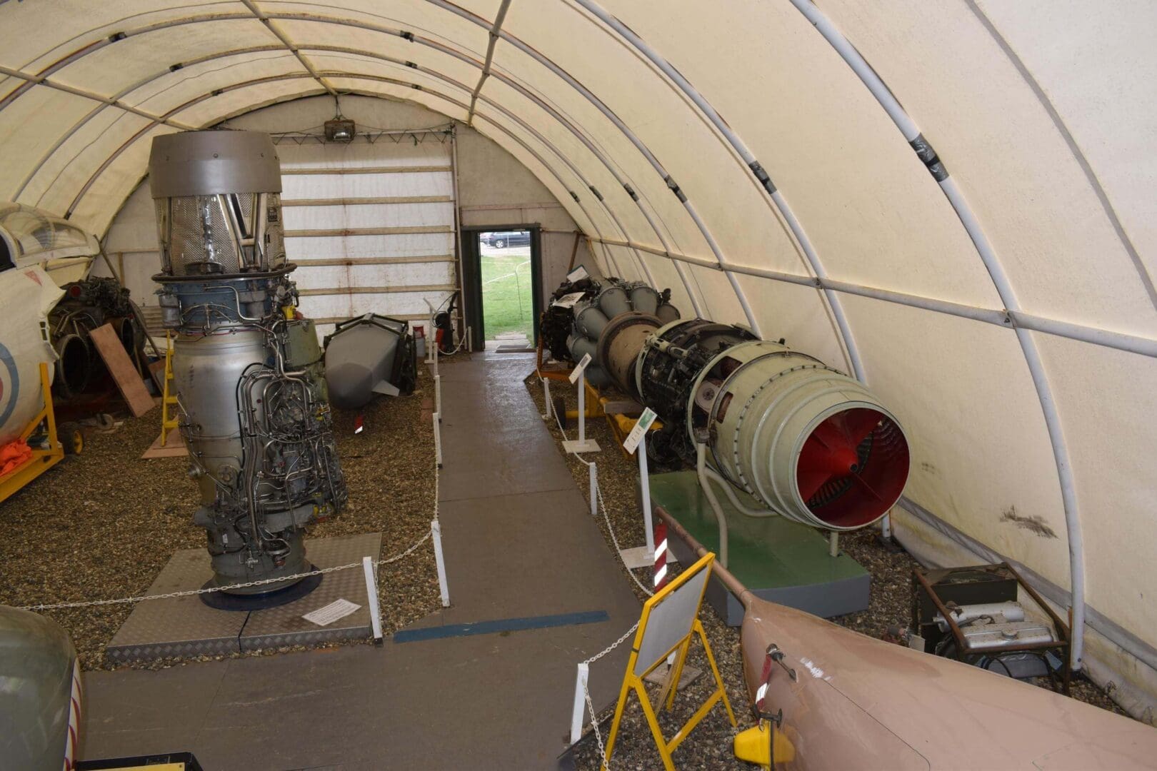 Aircraft engines displayed in a museum hangar.