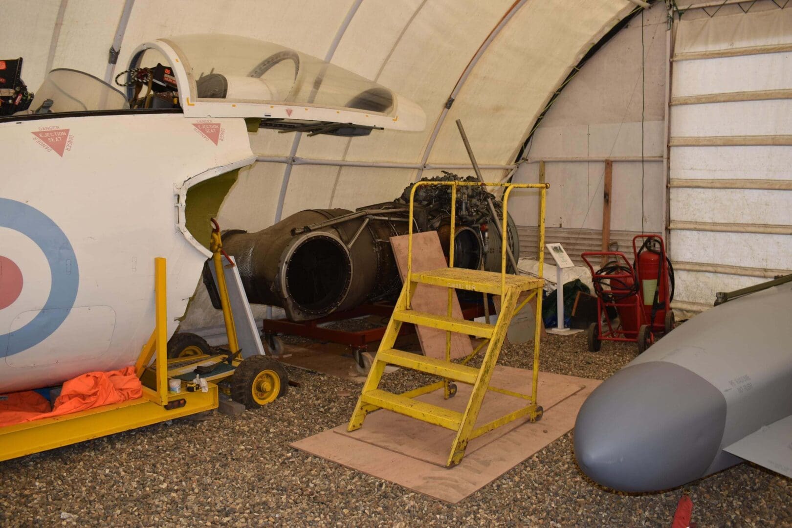 Aircraft parts inside a maintenance hangar.