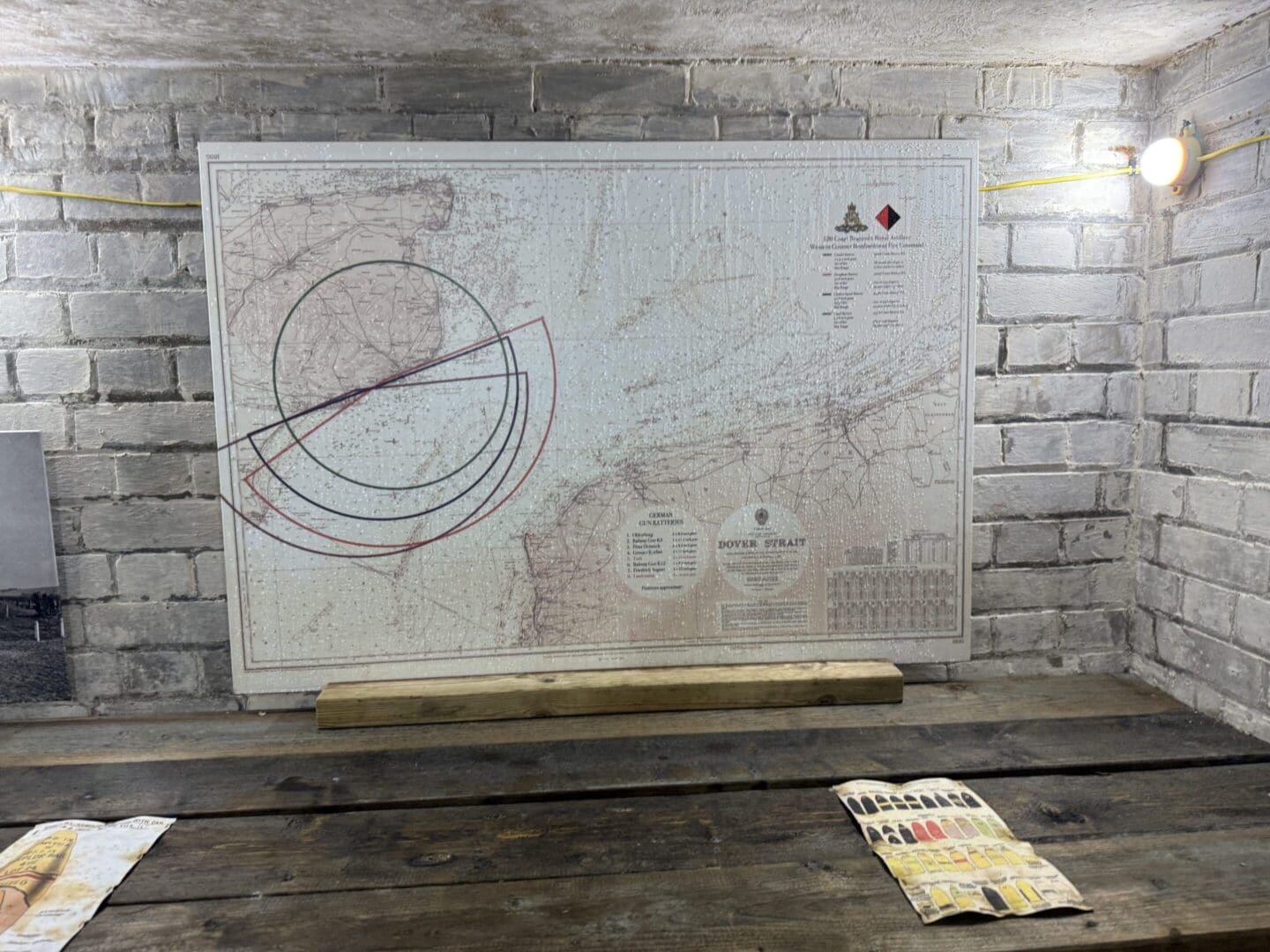 Map on brick wall with wooden table.