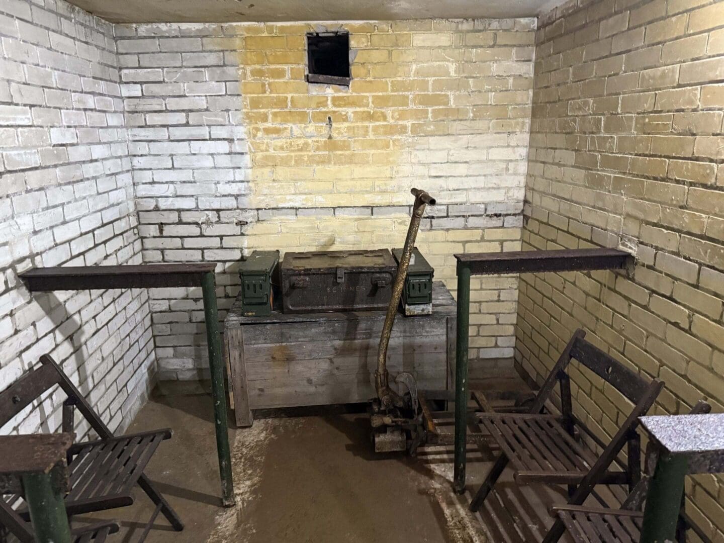 Basement room with chairs and old equipment.