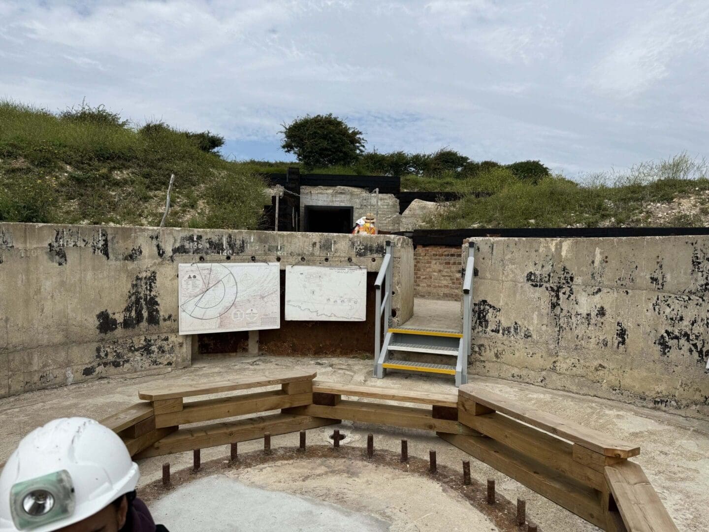 Outdoor fort with concrete walls and diagrams.