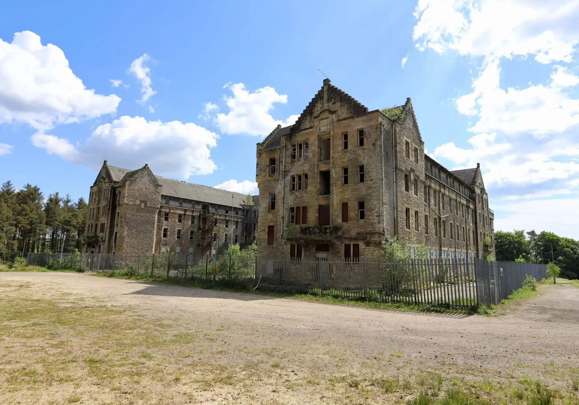 Abandoned stone building under blue sky.